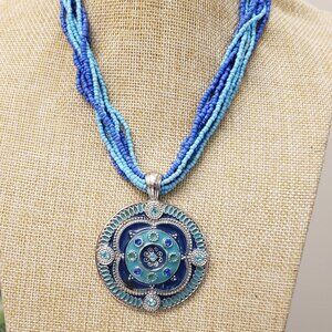 Turquoise, blue silver multi strand see bead ,heavy medallion pendant necklace